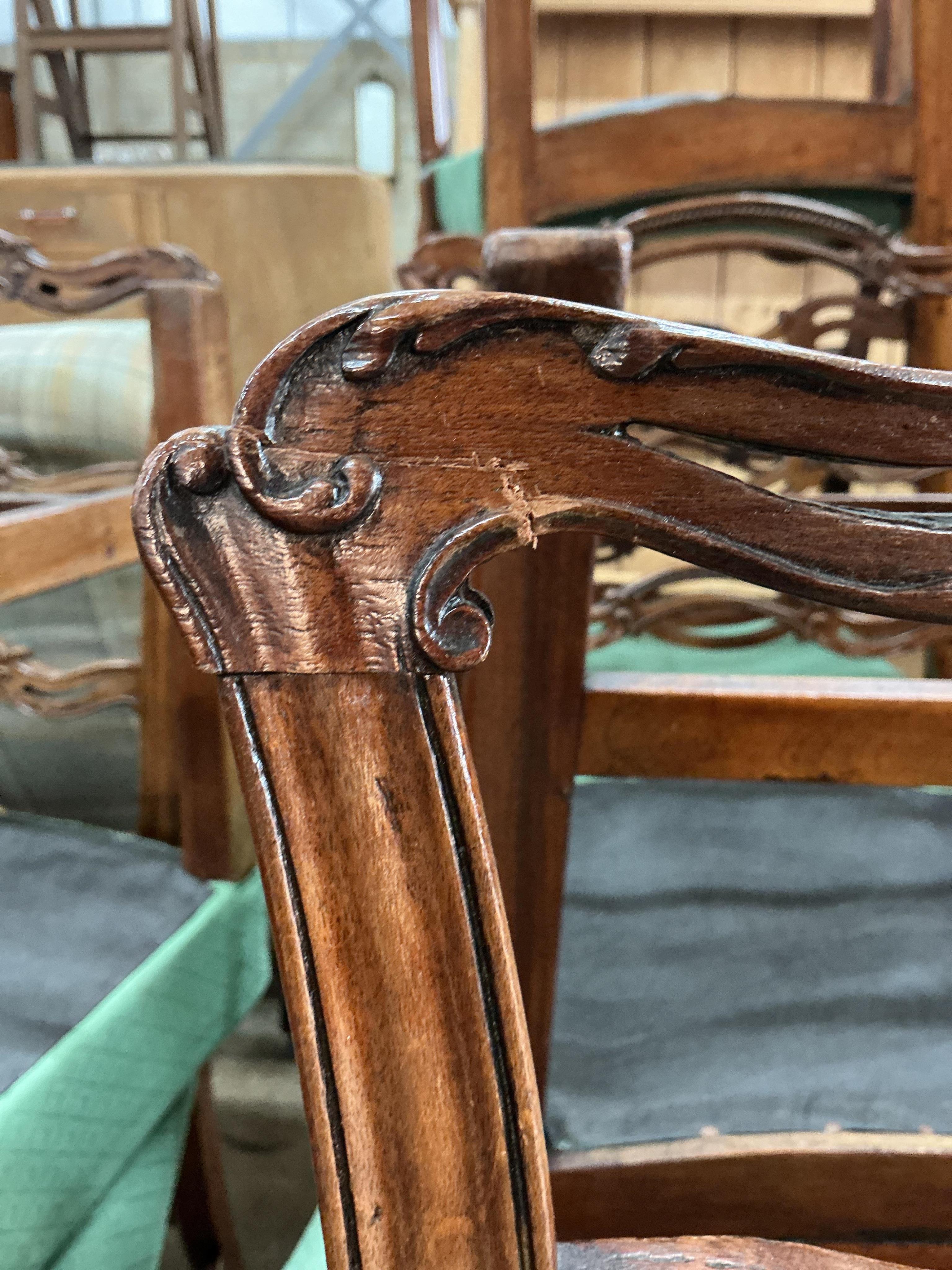 A set of nine George III mahogany pierced ladderback dining chairs, two with arms
